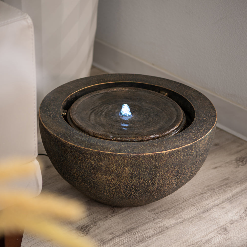 Luna Bowl — 19.8" Round LED Sphere Water Fountain, black, shown on a stone patio