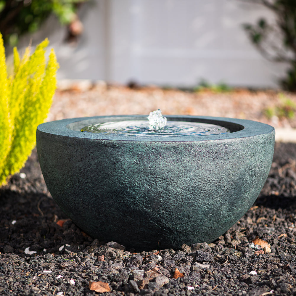 Luna Bowl — 19.8" Round LED Sphere Water Fountain, green, shown in the evening with water flowing